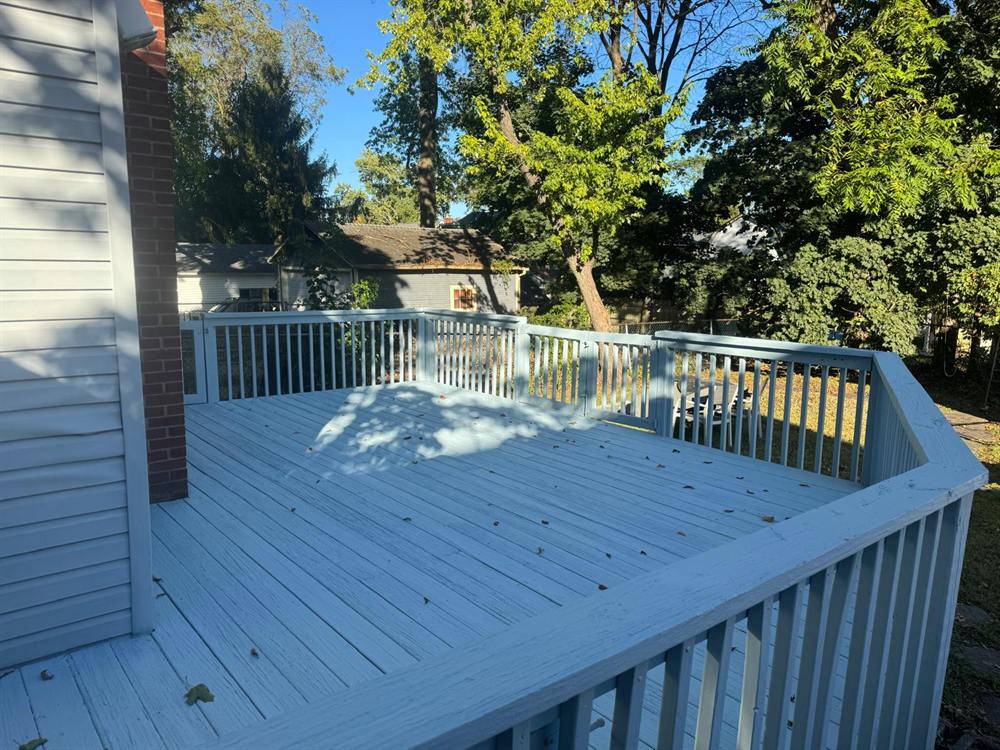 Backyard deck refinished in a soft blue-gray