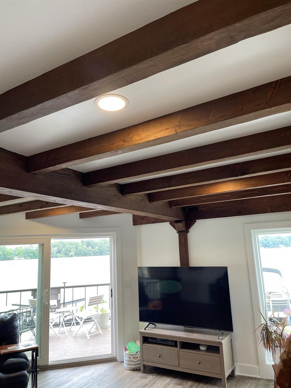 Lakeside living room with painted ceiling and exposed beams